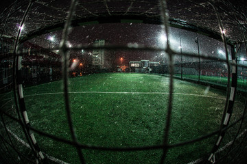 Soccer arena in night illuminated bright spotlights
