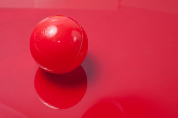 Plastic ball on a red background