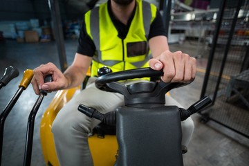 Factory worker driving forklift in factory © WavebreakMediaMicro