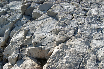 Layers of gray cracked rocks