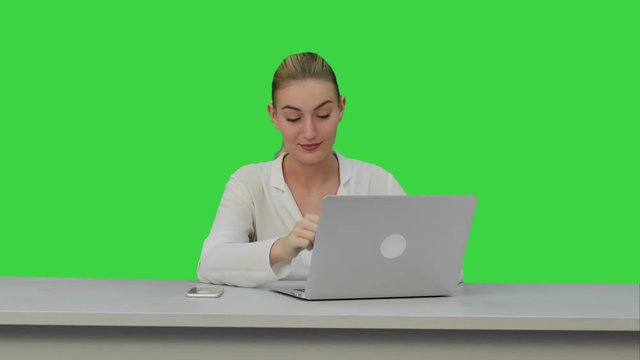 Young secretary tired at work place, yawn on a Green Screen, Chroma Key.