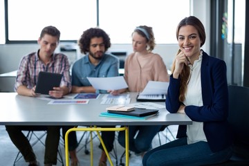 Portrait of female business executive sitting at desk