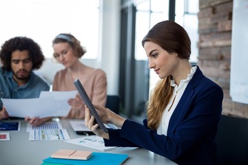 Female business executive using digital tablet in office