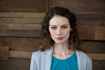 Confident female business executive standing in office