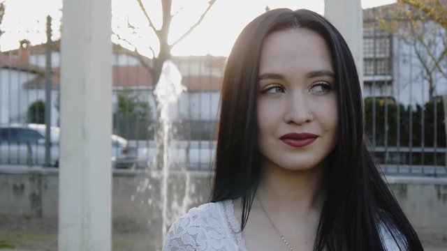 Portrait of young woman looking from right to left
