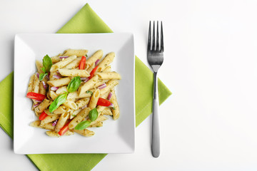 Plate with delicious pasta on white background