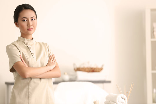 Young Asian masseur in spa salon