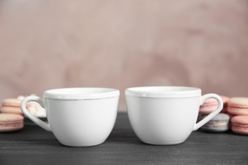 Obraz na płótnie Canvas White cups and cookies on grey table
