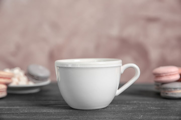 White cup and cookies on grey table