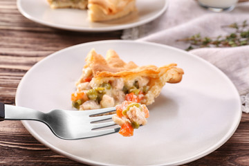 Fork with delicious chicken pot pie over plate