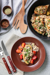 Plate with delicious chicken marsala and tomatoes on table
