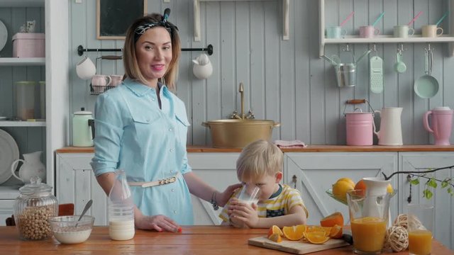 Mom Son Spend Time Holiday Eating Breakfast, mother and boy child on kichen, happy family