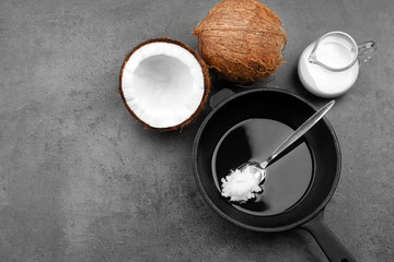 Spoon with coconut oil on frying pan