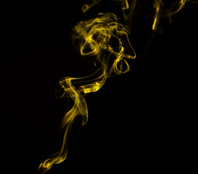 Swirl Of Yellow Smoke On Black Background