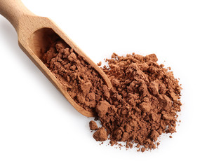 Heap of cocoa powder and wooden scoop on white background