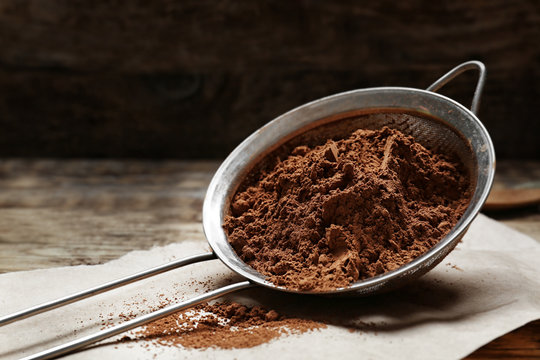 Metal Sieve With Cocoa Powder On Kitchen Table