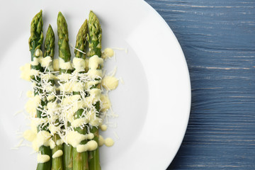 White plate of delicious asparagus with cheese cream, closeup