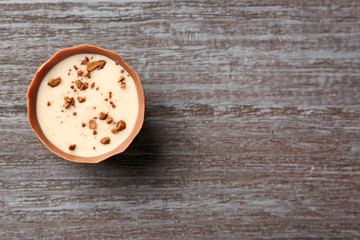 Delicious chocolate candy on wooden background
