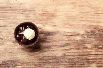 Delicious chocolate candy on wooden background