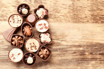 Fototapeta na wymiar Delicious chocolate candies on wooden background