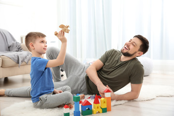 Father playing with his son at home