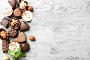 Delicious chocolate candies on wooden background © Africa Studio