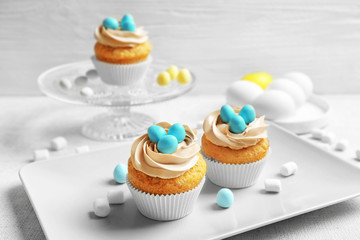 Easter cupcakes on table against grey background