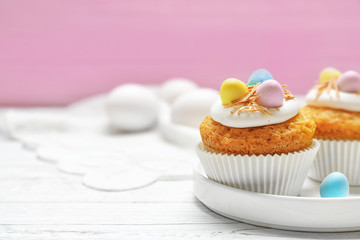 Fantastic Easter cupcakes on white wooden table and pink background