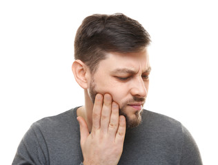 Fototapeta premium Handsome man suffering from toothache on white background