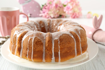 Plate with tasty Easter cake on table