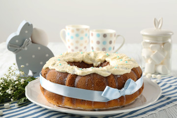 Plate with tasty Easter cake on table