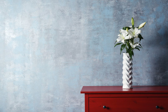 Fototapeta Beautiful white lilies in vase on table