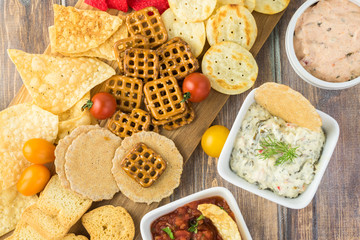 Variety of snacks with dips and salsa.