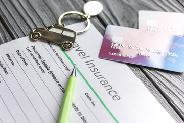 Travel preparation concept with insurance and cards on wooden table