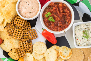 Party tray for soccer game with variety of snacks and dips.