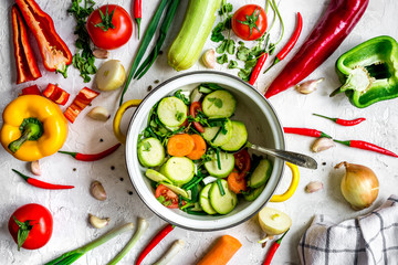 cooking vegetables on the stone background top view