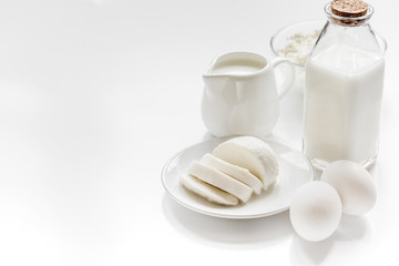monochrome concept with dairy products on white table mock up