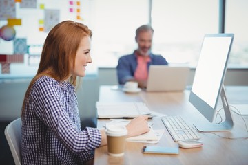 Female executive working on computer