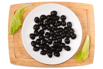 Vegetables on white background. Olives, greens, cutting board, plate on a white background