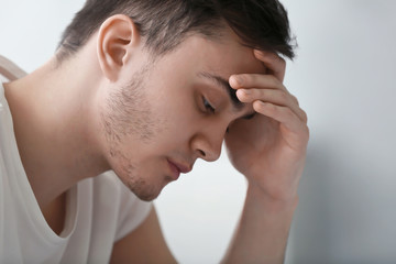 Fototapeta premium Handsome depressed man at home, closeup