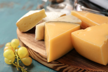 Assortment of cheese on wooden board, closeup