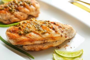 Delicious chicken breasts with lime on plate