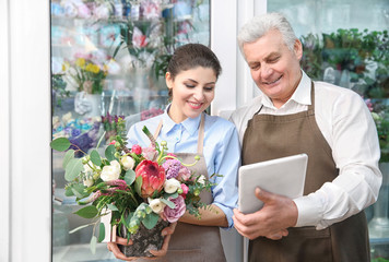 Male and female florists in flower shop