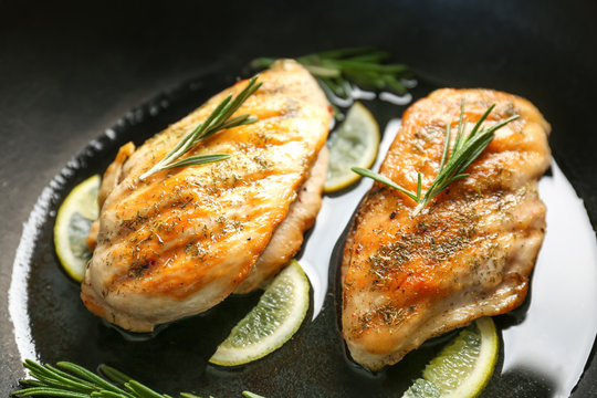 Delicious chicken breasts in frying pan, closeup