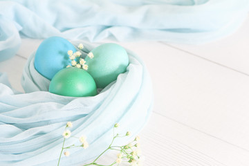 Colorful easter eggs  on a white wooden background. Space for text. Top view
