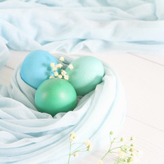 Colorful easter eggs  on a white wooden background. Space for text. Top view
