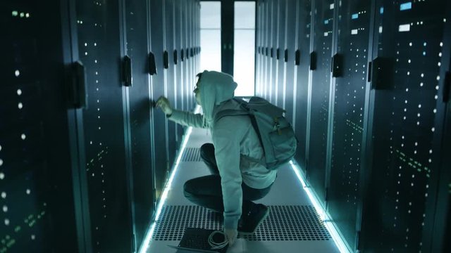 Following Shot of a Hacker With Notebook Breaking into Corporate Data Center and Connecting to It's Server.  Shot on RED EPIC-W 8K Helium Cinema Camera.