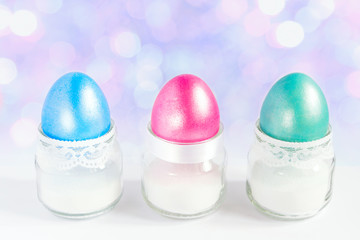 Colored easter eggs in white egg cups. Selective focus