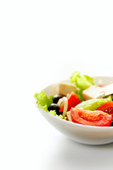 Fresh vegetable salad isolated on white background. Selective focus and space for text, vertical format