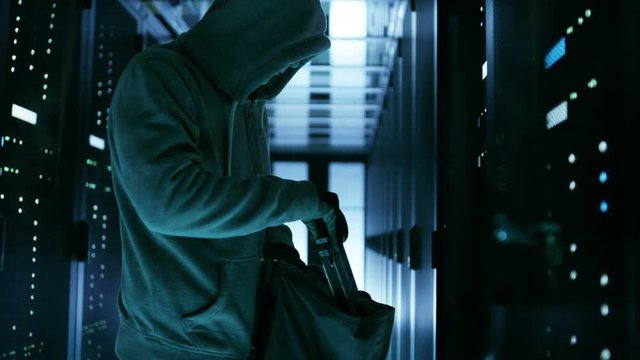  Hacker in a Hoodie Steals Hard Drives from Corporate Data Center Rack Server.Shot on RED EPIC-W 8K Helium Cinema Camera.